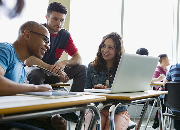 Students in a classroom making an MLA style bibliography