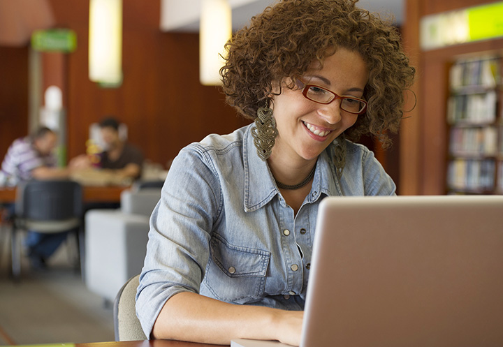 Young woman typing APA Bible citation examples